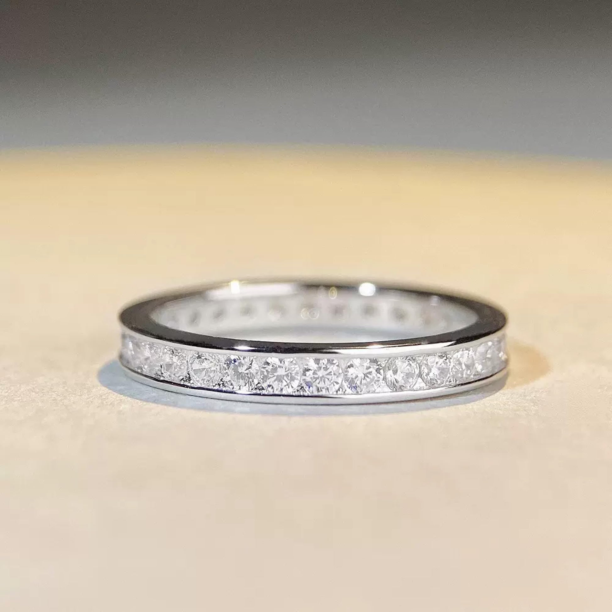 Silver eternity ring with pavé round stones across the top, low profile view