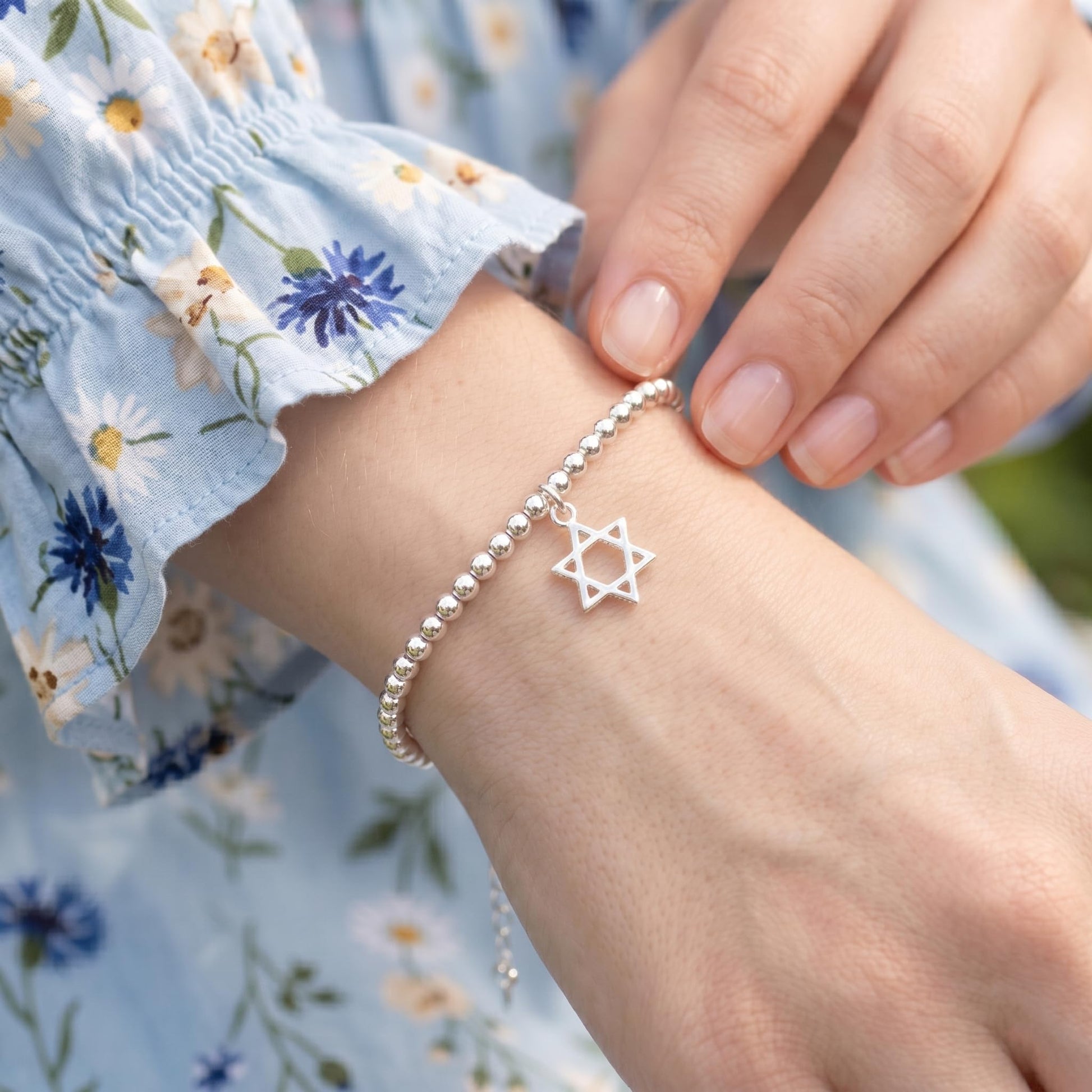 Star of David hollow charm on beaded bracelet, silver-tone