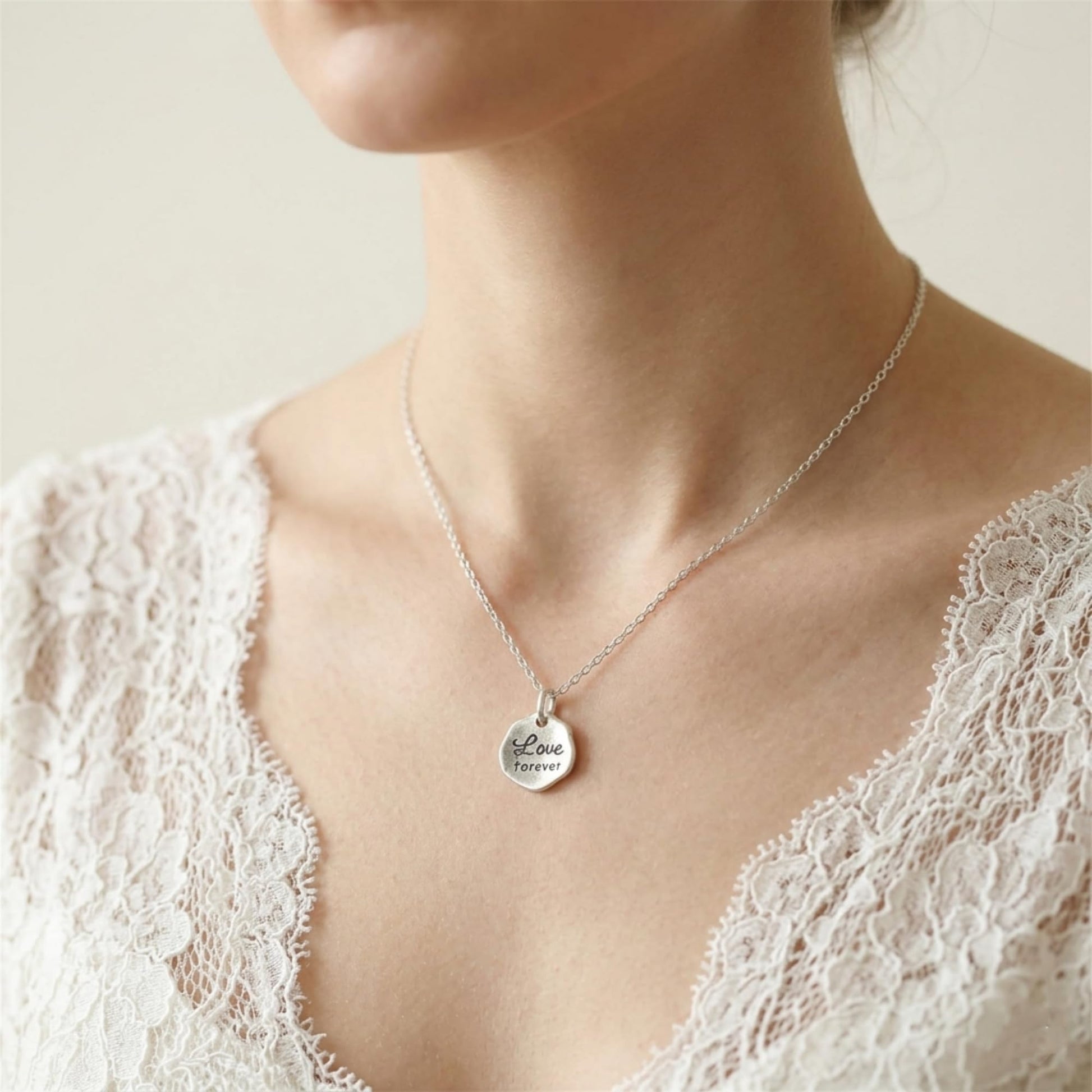 Silver-tone necklace with “Love forever” hexagon pendant charm