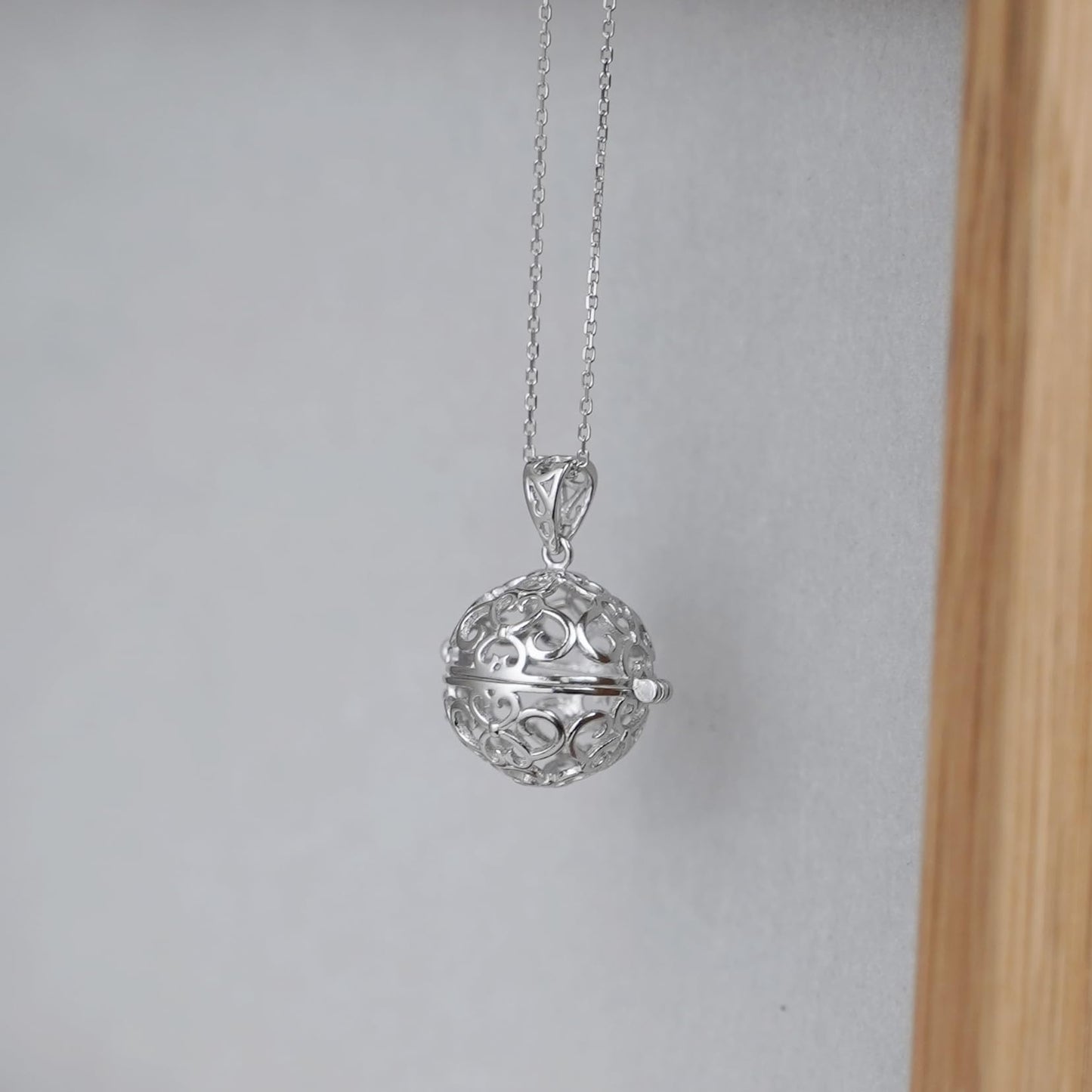 Rhodium curb belcher chain necklace with filigree ball pendant, silver tone.