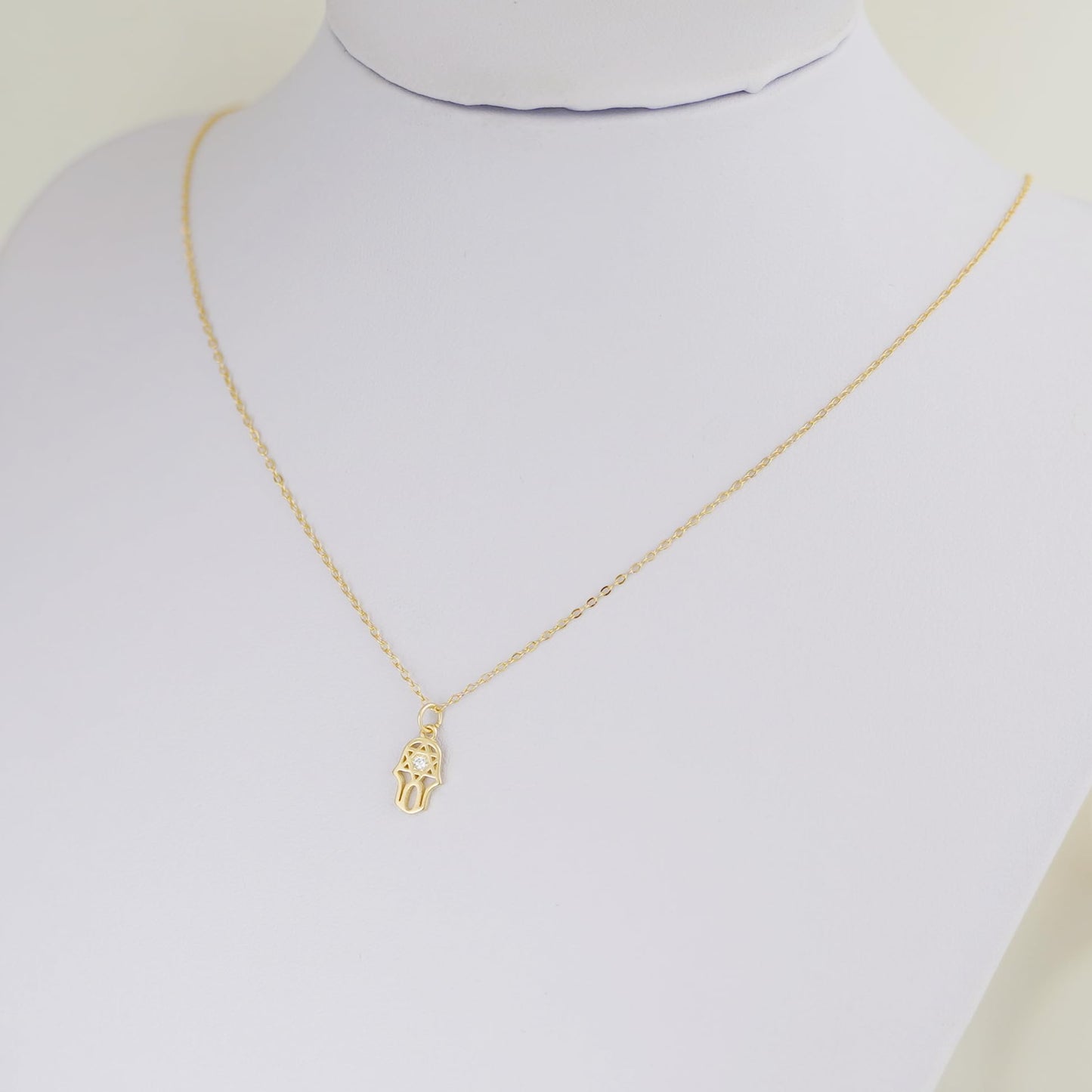 Gold-tone link chain necklace with hamsa hand charm