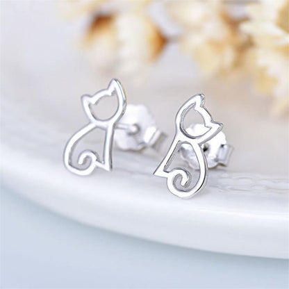 Pair of silver cat silhouette stud earrings with outline swirl tail