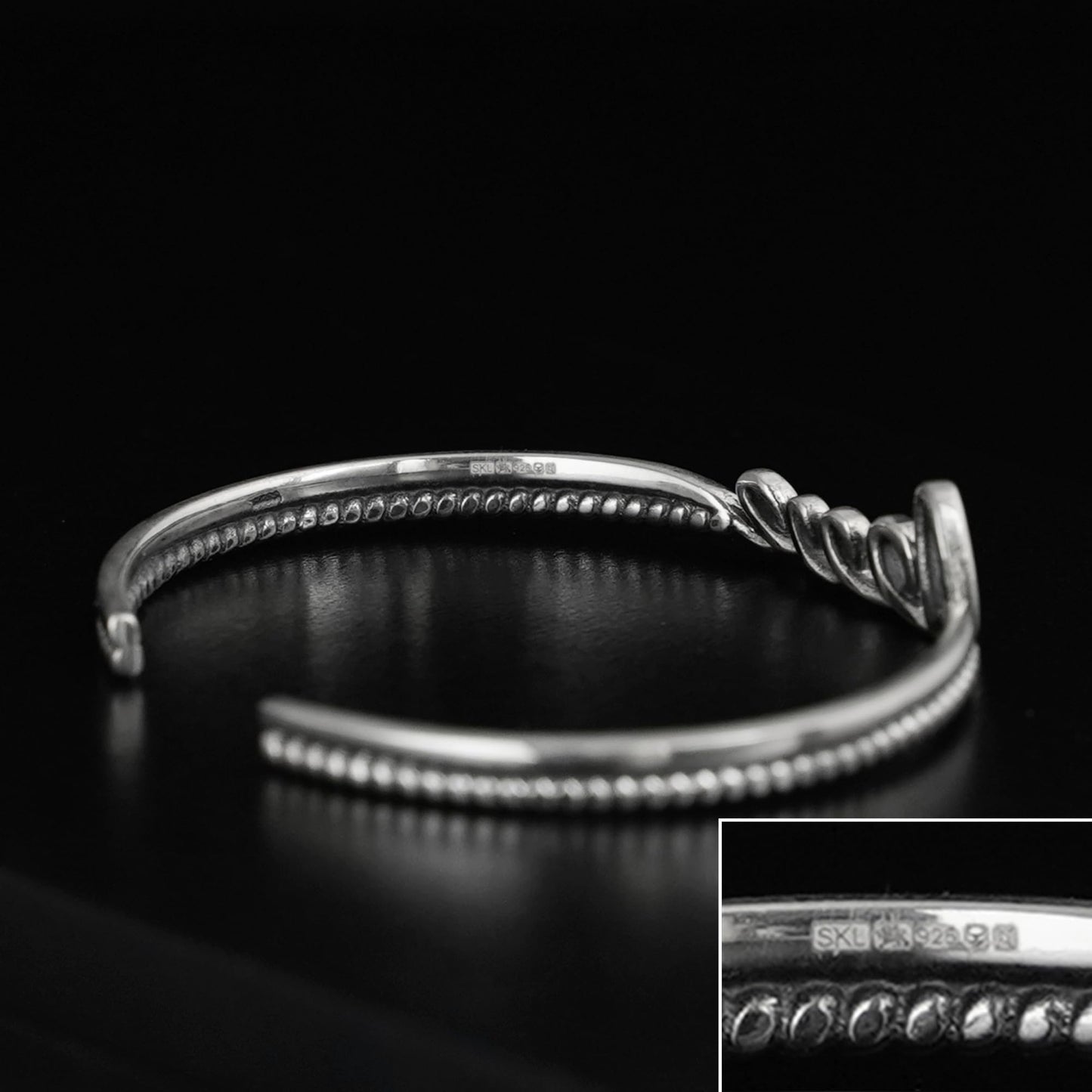 Silver rope-cuff bracelet with beaded ridges and a knot charm detail.