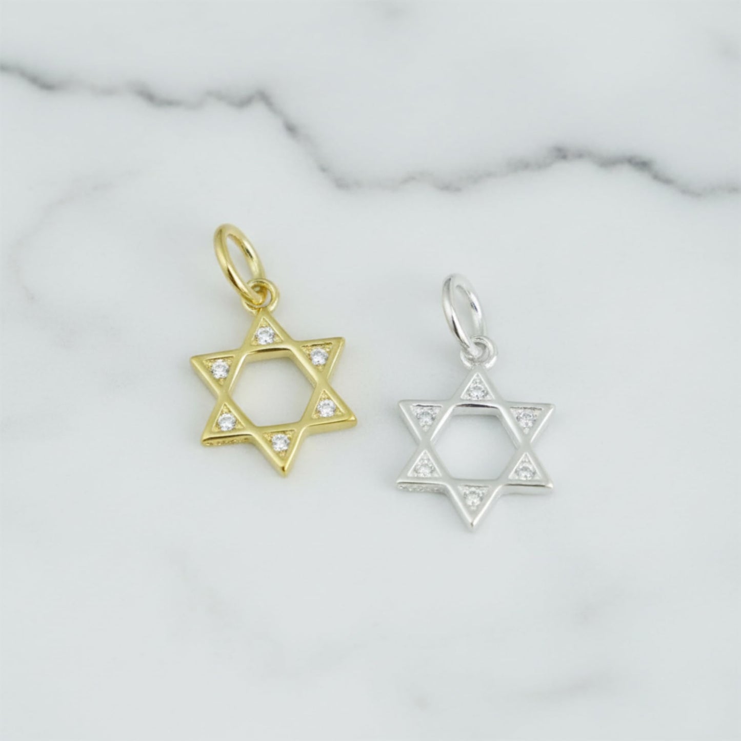 Star of David pendant charms in gold and silver tones with clear-stone detail