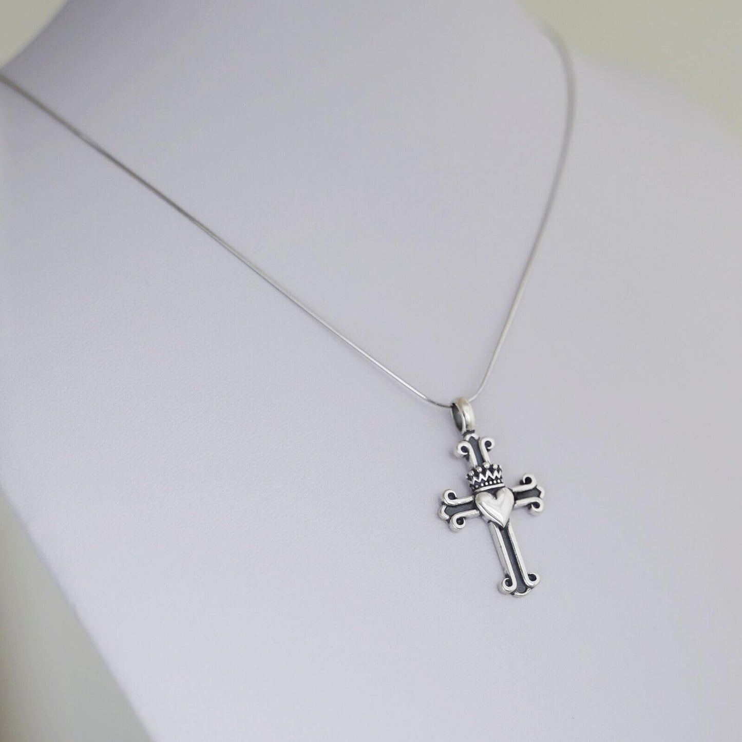 Silver snake chain necklace with sword-and-cross charm pendant