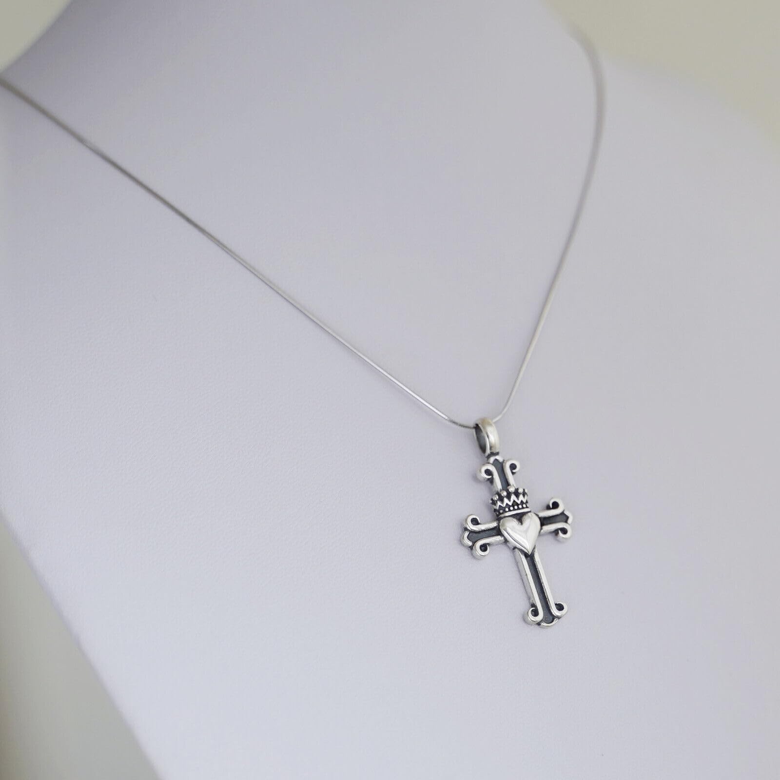Silver snake chain necklace with sword-and-cross charm pendant