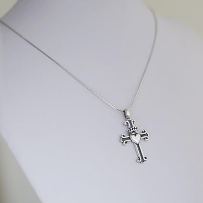Silver snake chain necklace with sword-and-cross charm pendant