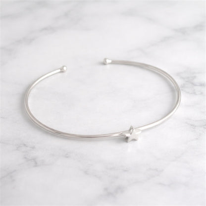 Silver star charm bangle bracelet with open ends and star accent