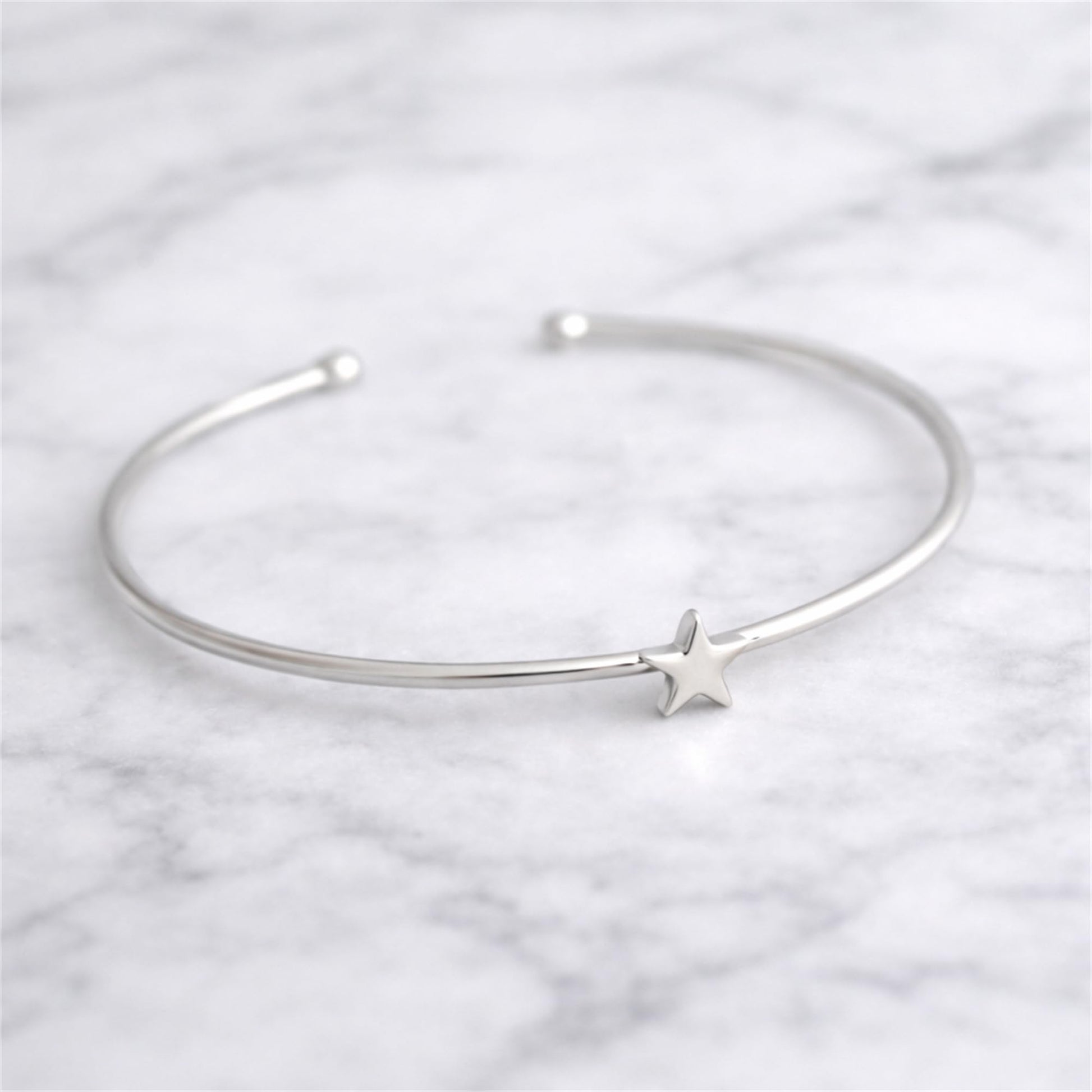 Silver star charm torque bangle bracelet with open cuff and star detail