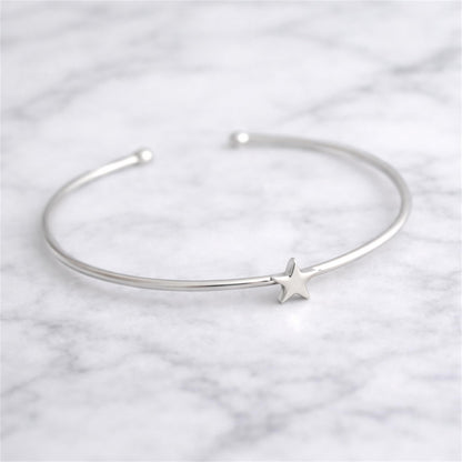 Silver star charm torque bangle bracelet with open cuff and star detail