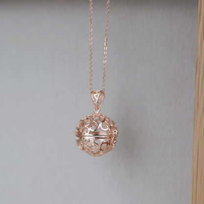 Rose gold-tone necklace with round filigree ball charm and link chain
