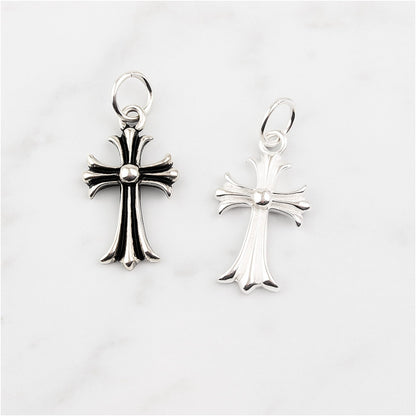 Fleur-de-lis cross charm hook earrings, one plain silver and one oxidised silver