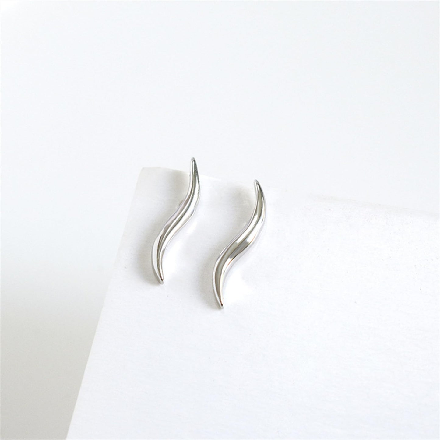 Silver wavy vine climber stud earrings, side view with curved wave detail