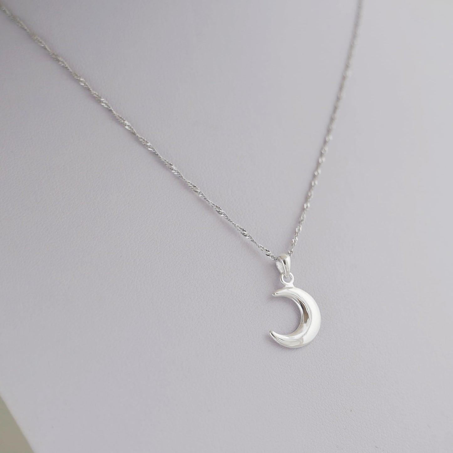 Rhodium twisted chain necklace with crescent moon pendant