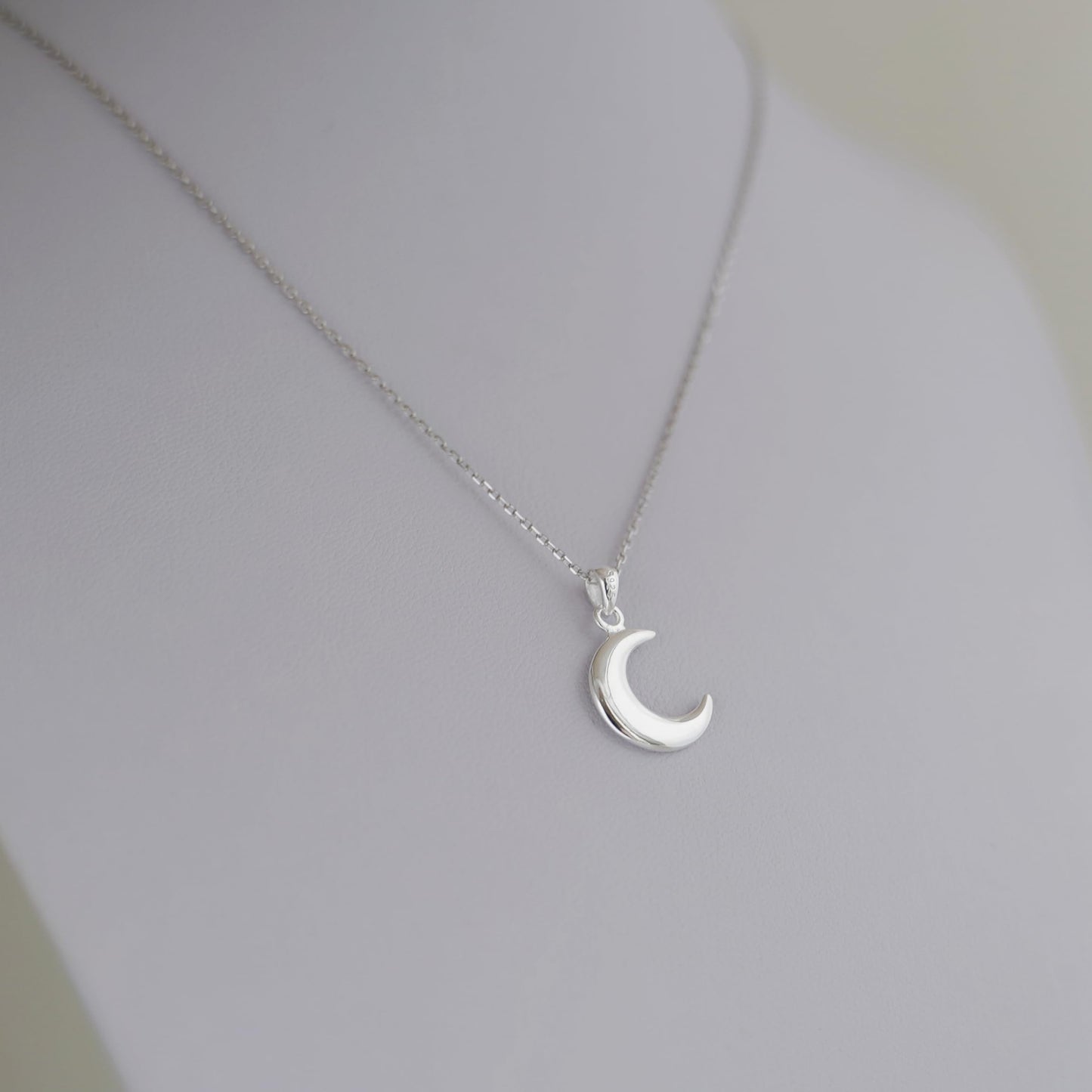 Rhodium curb belcher chain necklace with crescent moon pendant, silver tone.