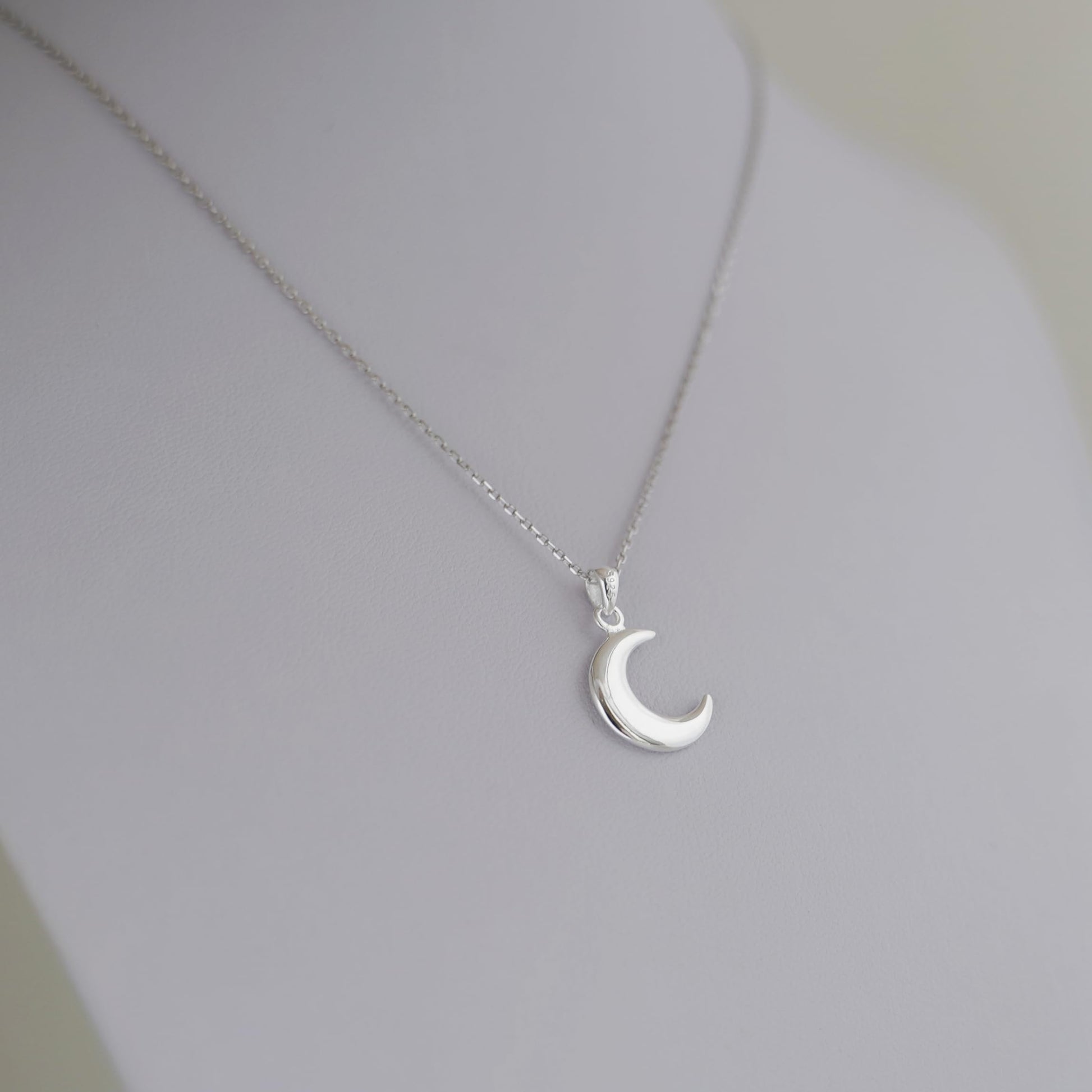 Rhodium curb belcher chain necklace with crescent moon pendant, silver tone.