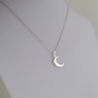 Rhodium curb belcher chain necklace with crescent moon pendant, silver tone.