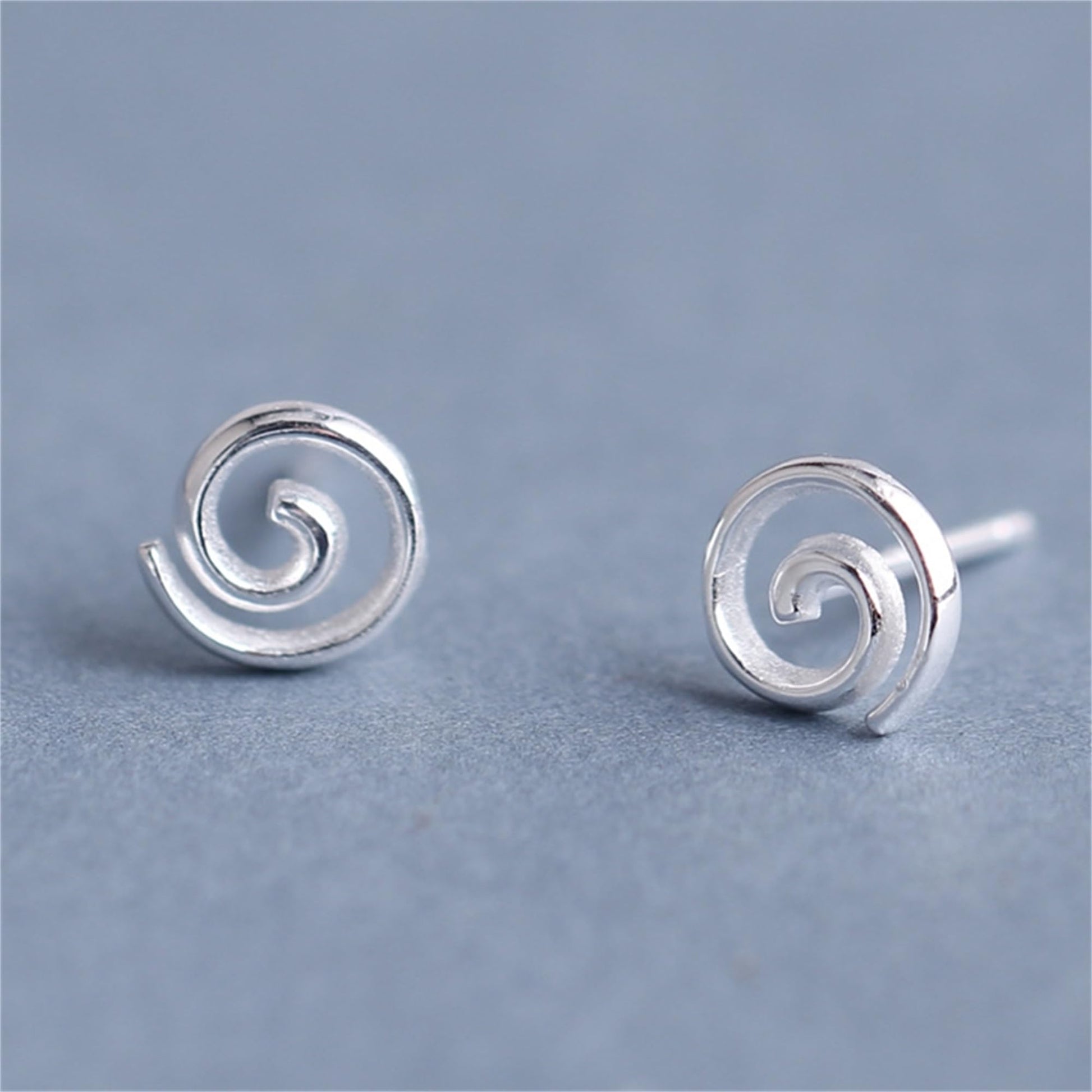 Silver spiral swirl stud earrings, small round backs with curled swirl detail.