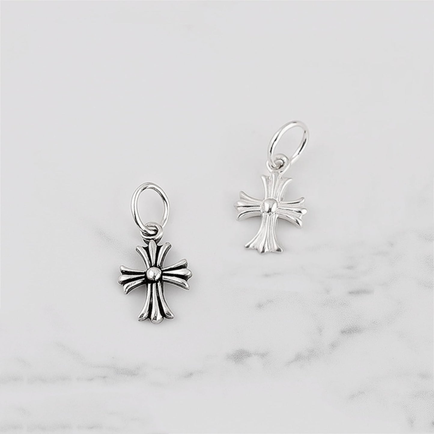 Fleur-de-lis cross charm hook earrings in plain silver, two views