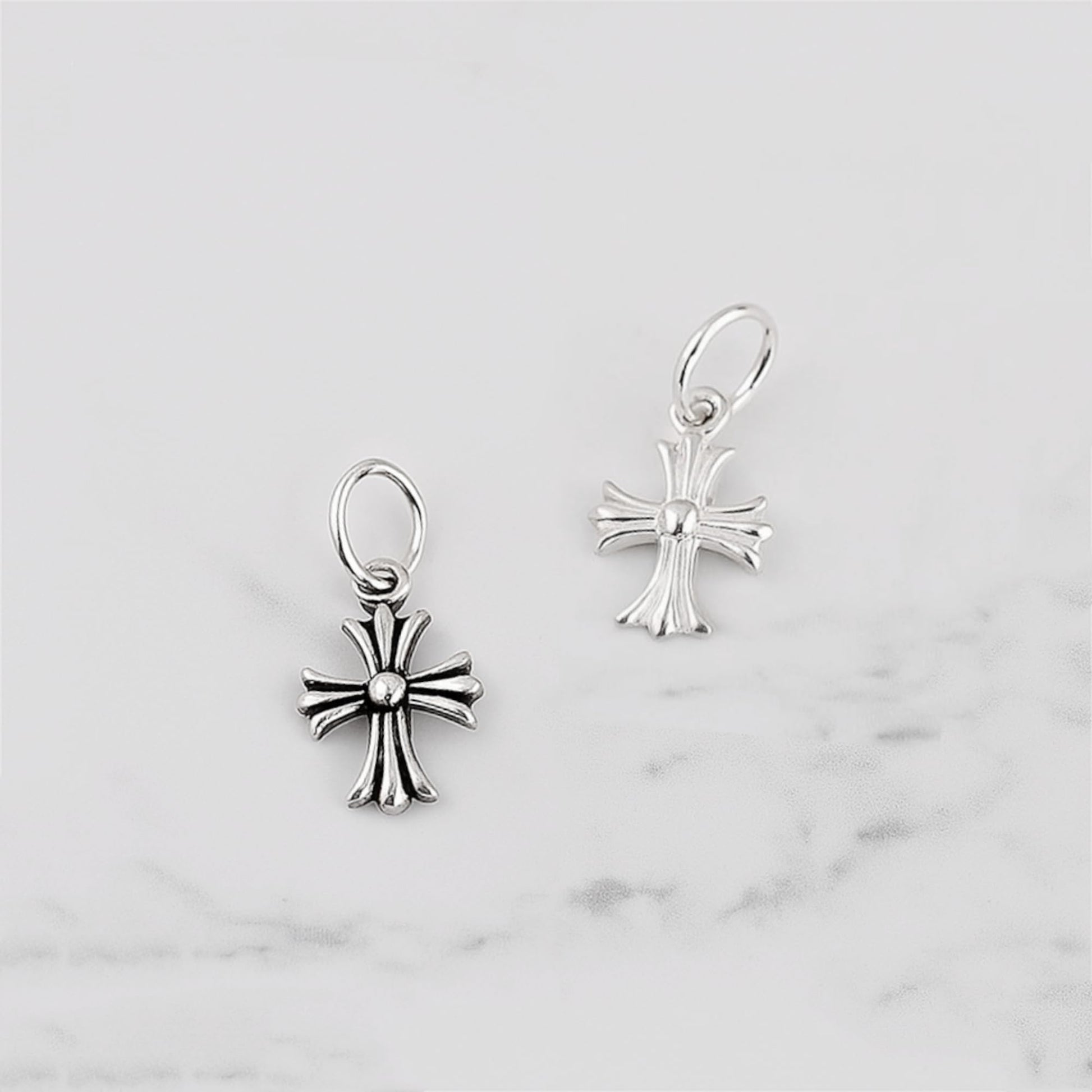 Fleur-de-lis cross charm hook earrings in plain silver, two views