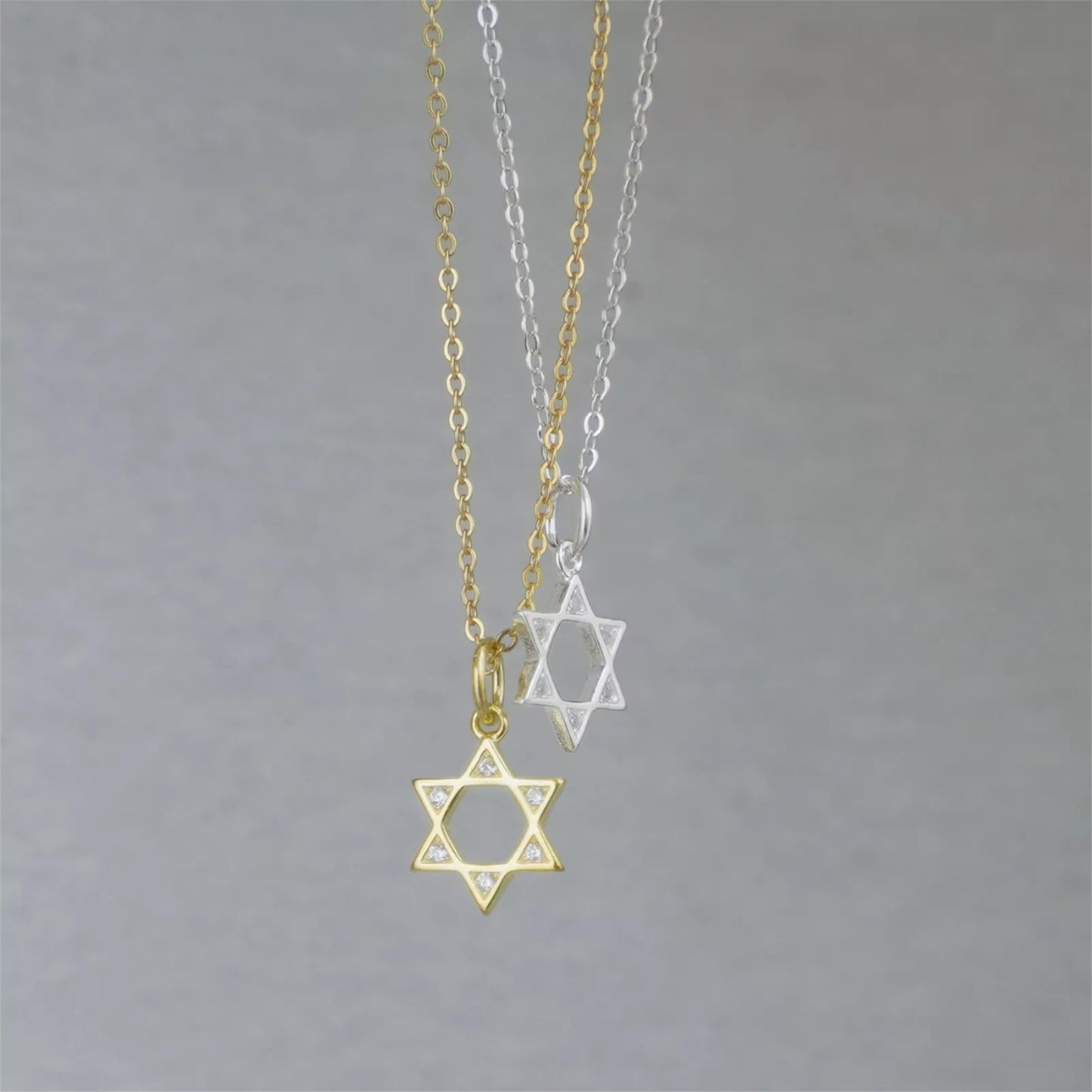 Star of David necklace set with gold and silver pendants and round gemstones