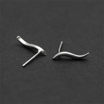 Silver wavy vine climber stud earrings shown at angles with post backing