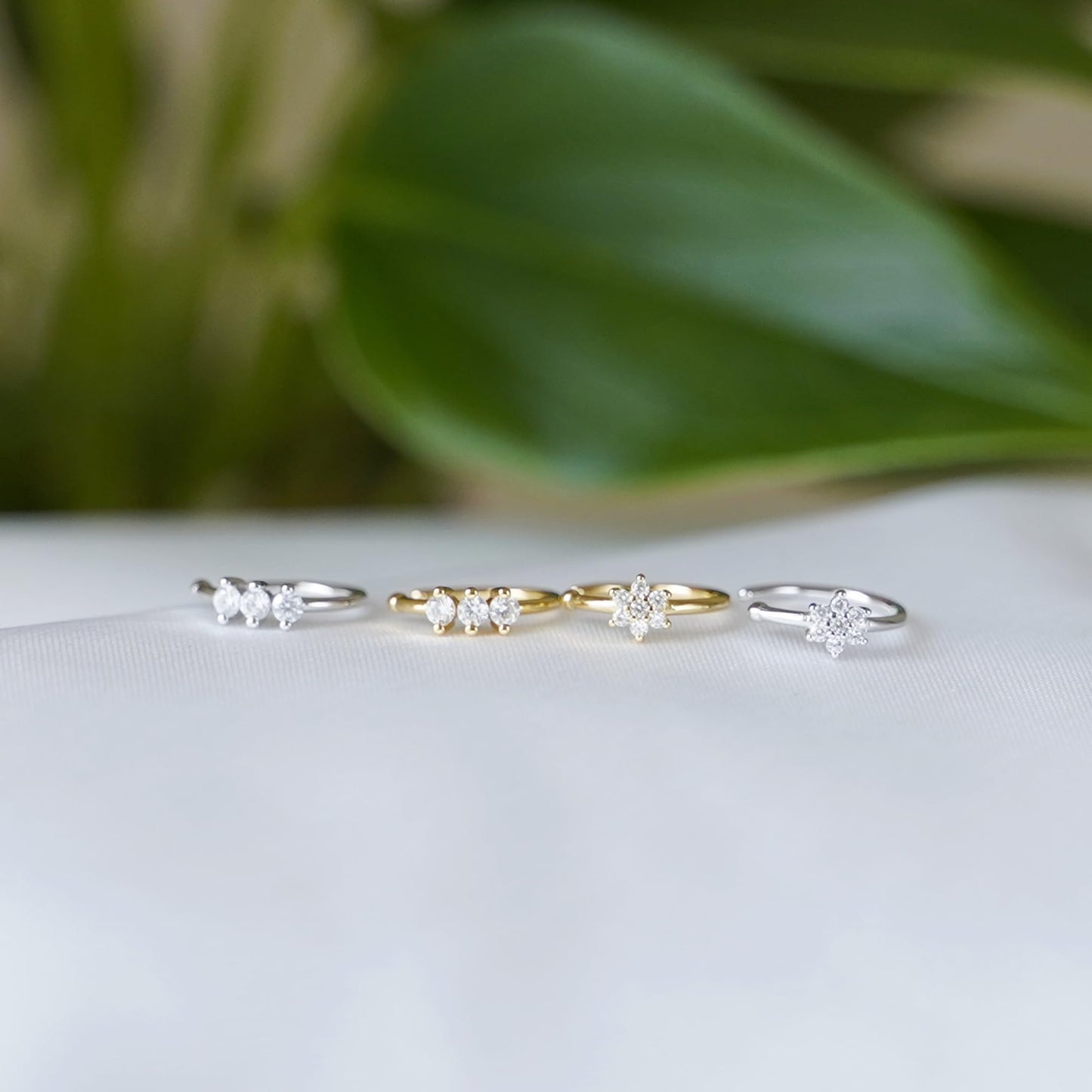 Set of CZ floral cuff hoops with small flower clusters, in silver and gold.