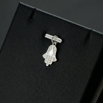 Silver hamsa hand charm pendant on a clasp, with openwork cutout details