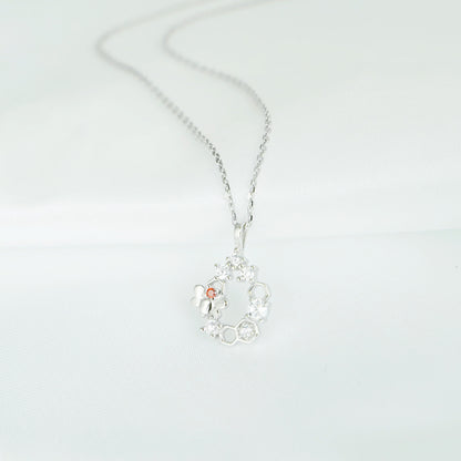 Silver-tone honeycomb necklace pendant with bee and sparkling hexagon charms