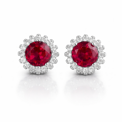 Silver stud earrings with round red gemstone cluster surrounded by small clear stones