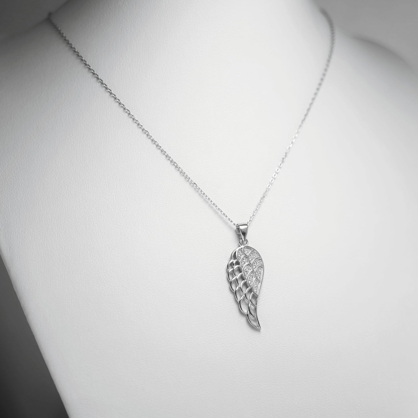Rhodium curb belcher chain necklace with angel wings pendant, silver tone.
