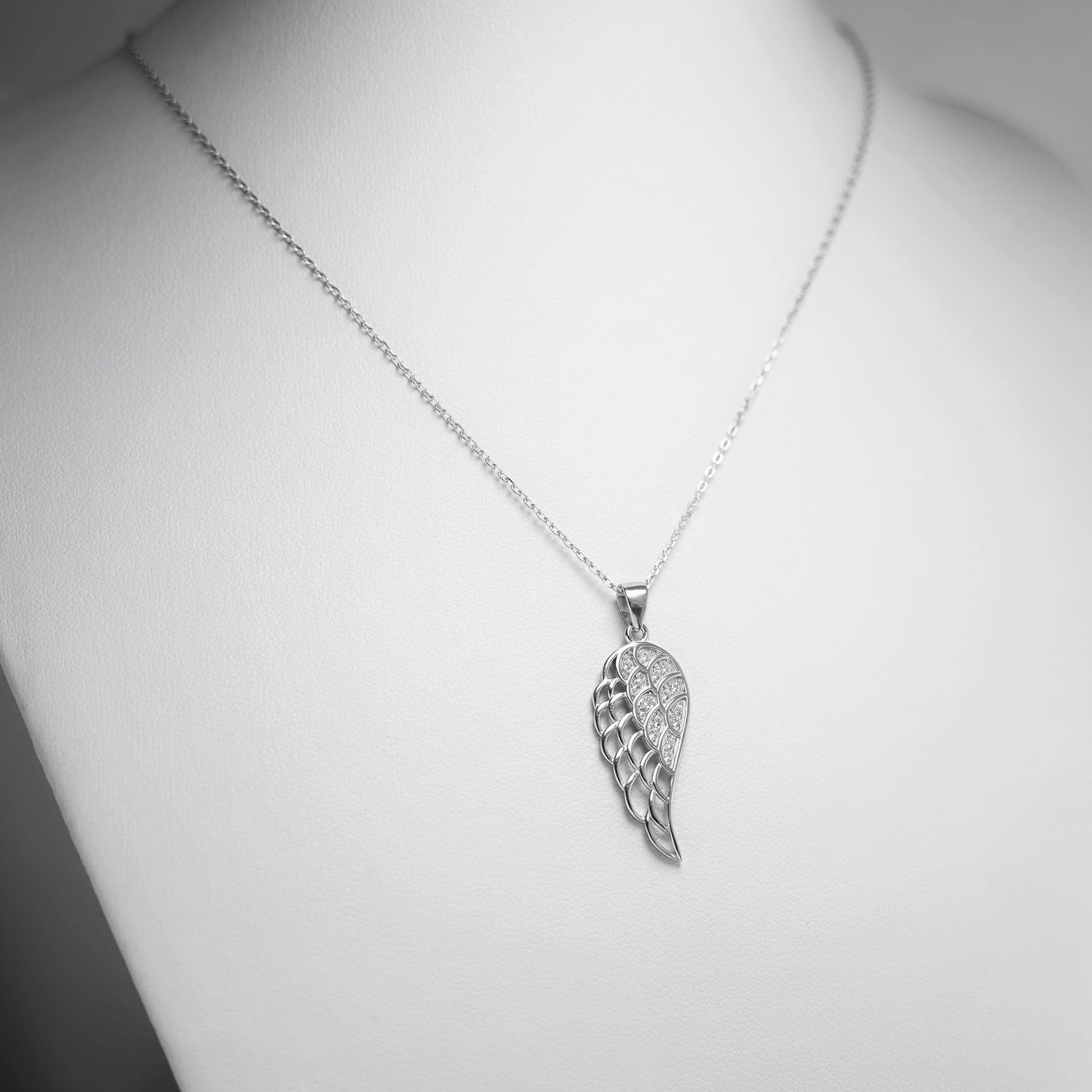 Rhodium curb belcher chain necklace with angel wings pendant, silver tone.