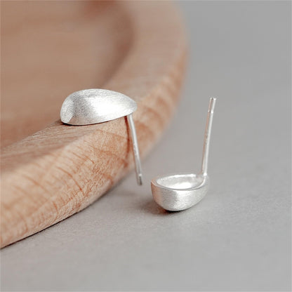 Teardrop stud earrings with silver-toned posts on fingertip