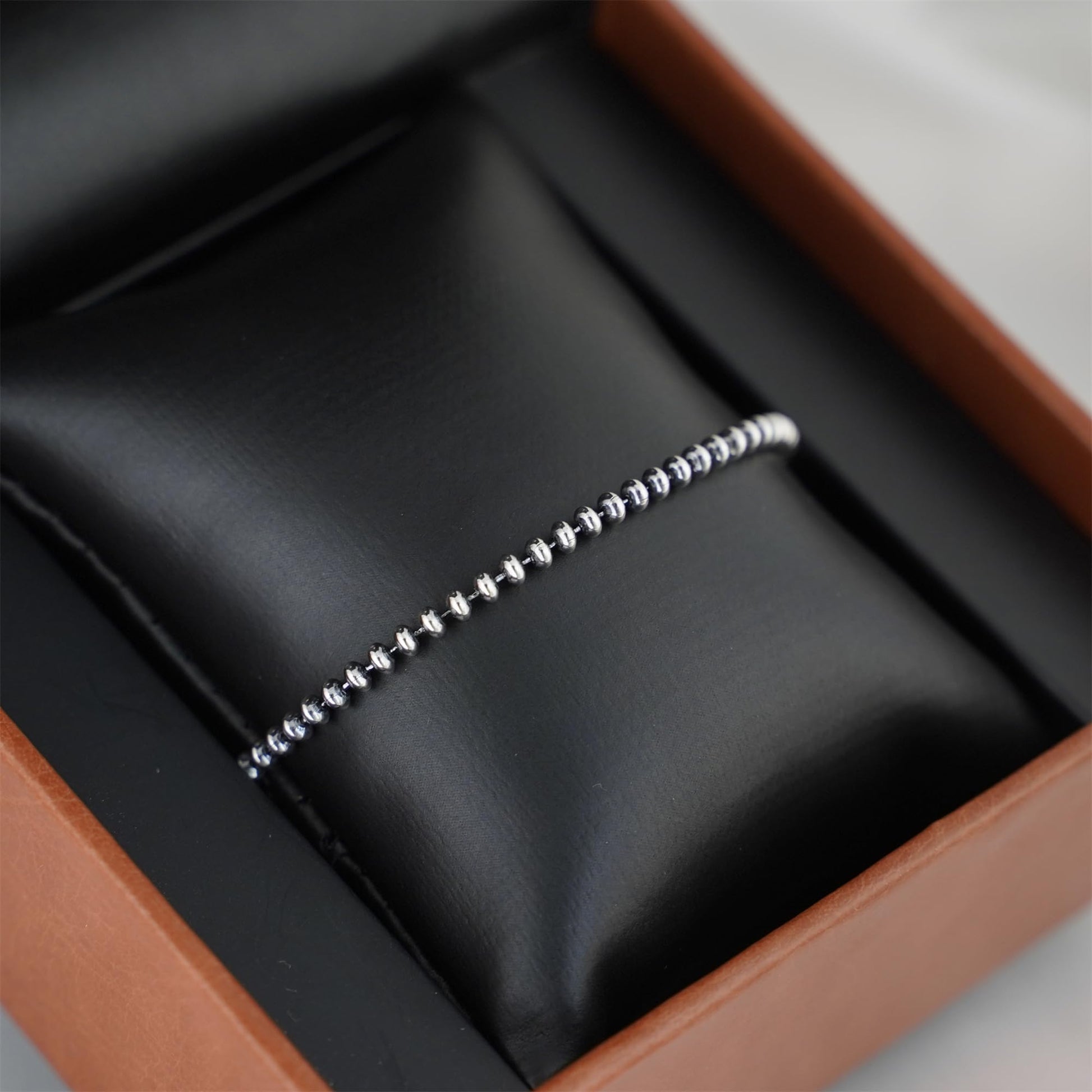 Silver-tone flat bead bracelet in box, beaded links and clasp end