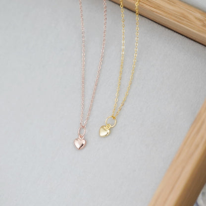 Heart charm necklace set with mixed link chains in rose, gold, and silver tones