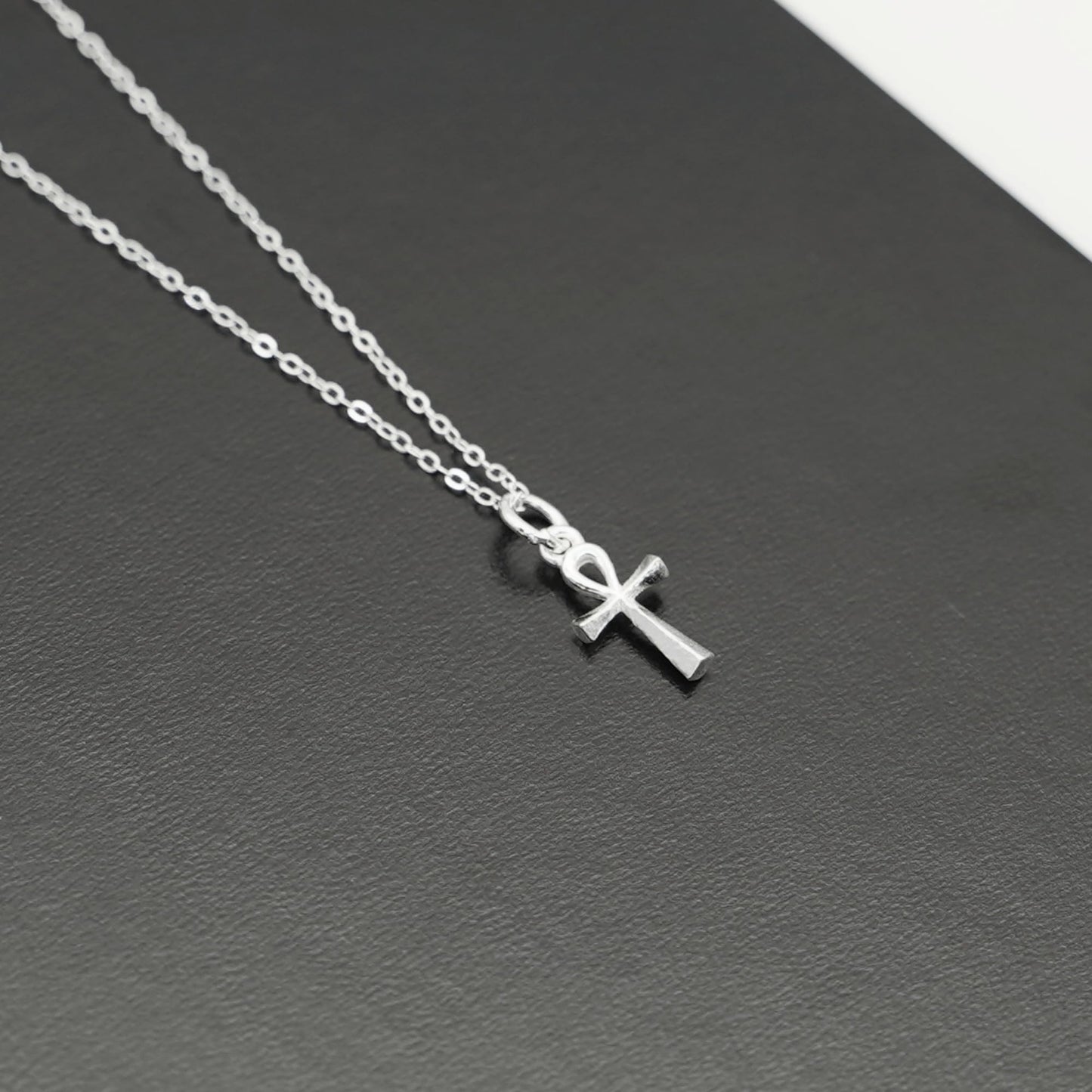 Silver ankh cross pendant charm with chain links, side view