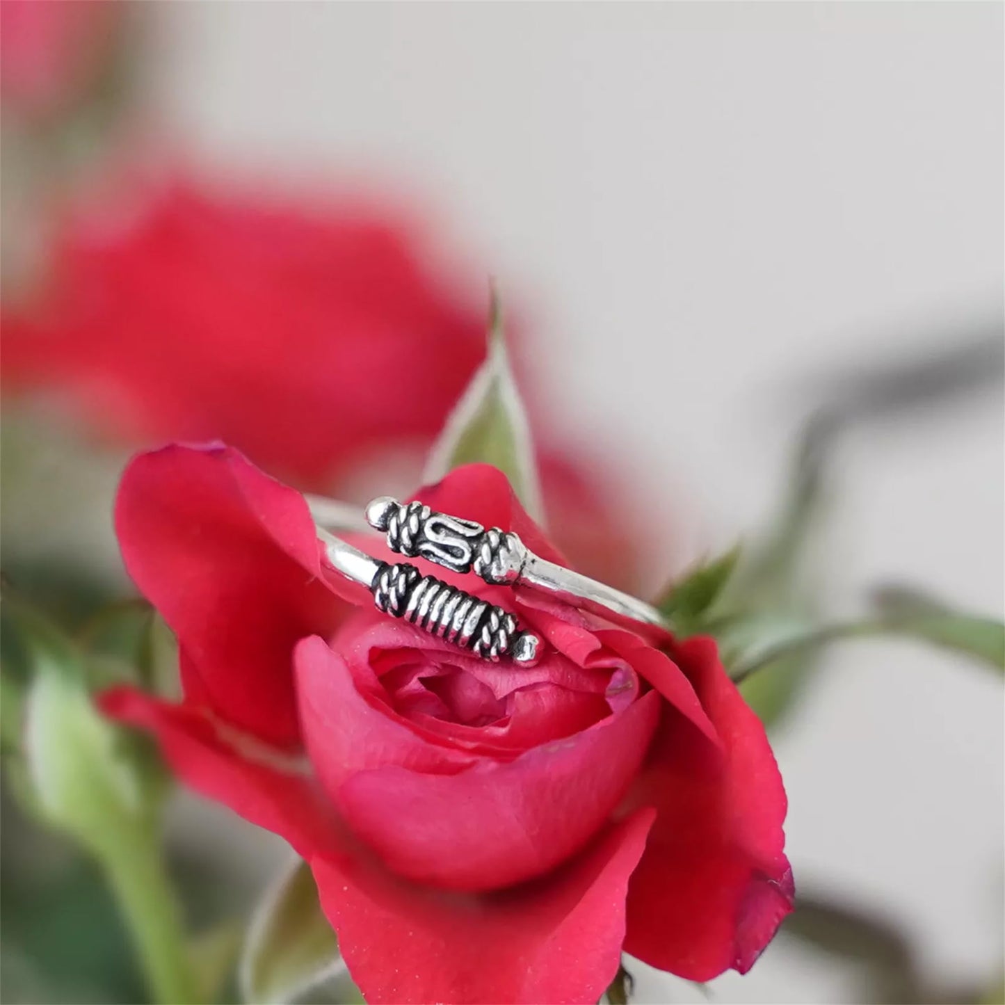Oxidized silver totem knot ring with textured ridges and raised knot design