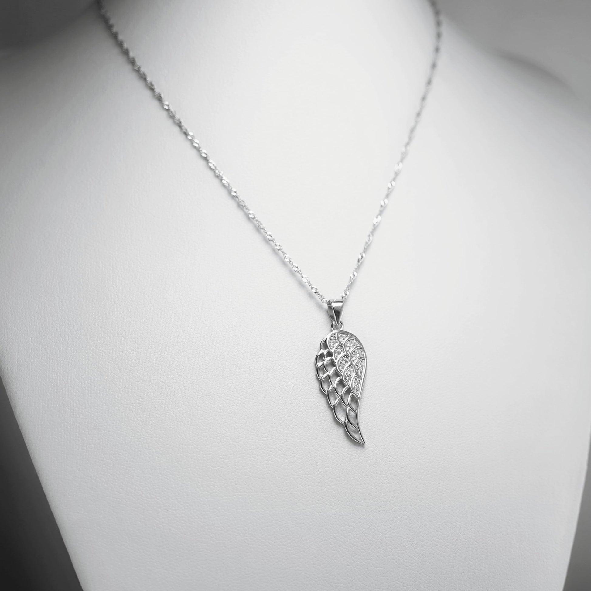 Rhodium twisted chain necklace with wing-shaped charm pendant