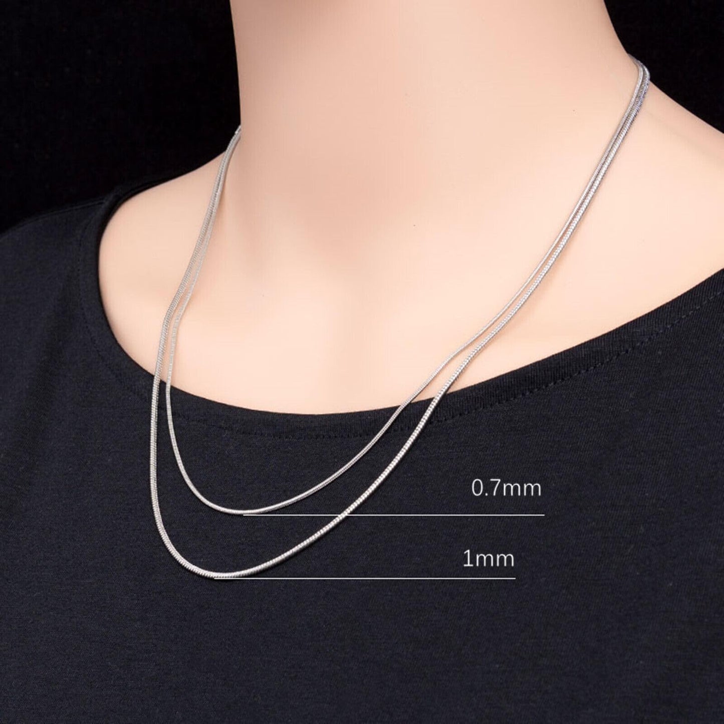 Snake chain necklace on chest, thin silver chains shown in 0.7mm and 1mm thickness