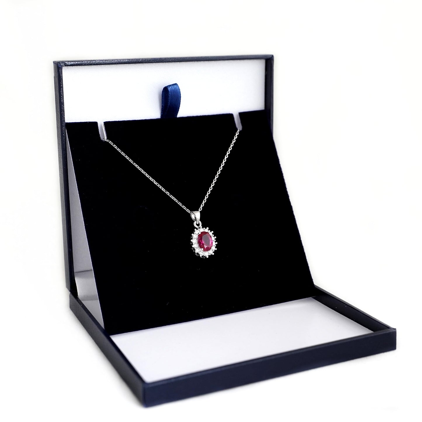 Rhodium curb belcher chain necklace with red gemstone heart pendant, silver tone.