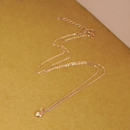 Rose gold-tone mixed link chain necklace with small heart charm