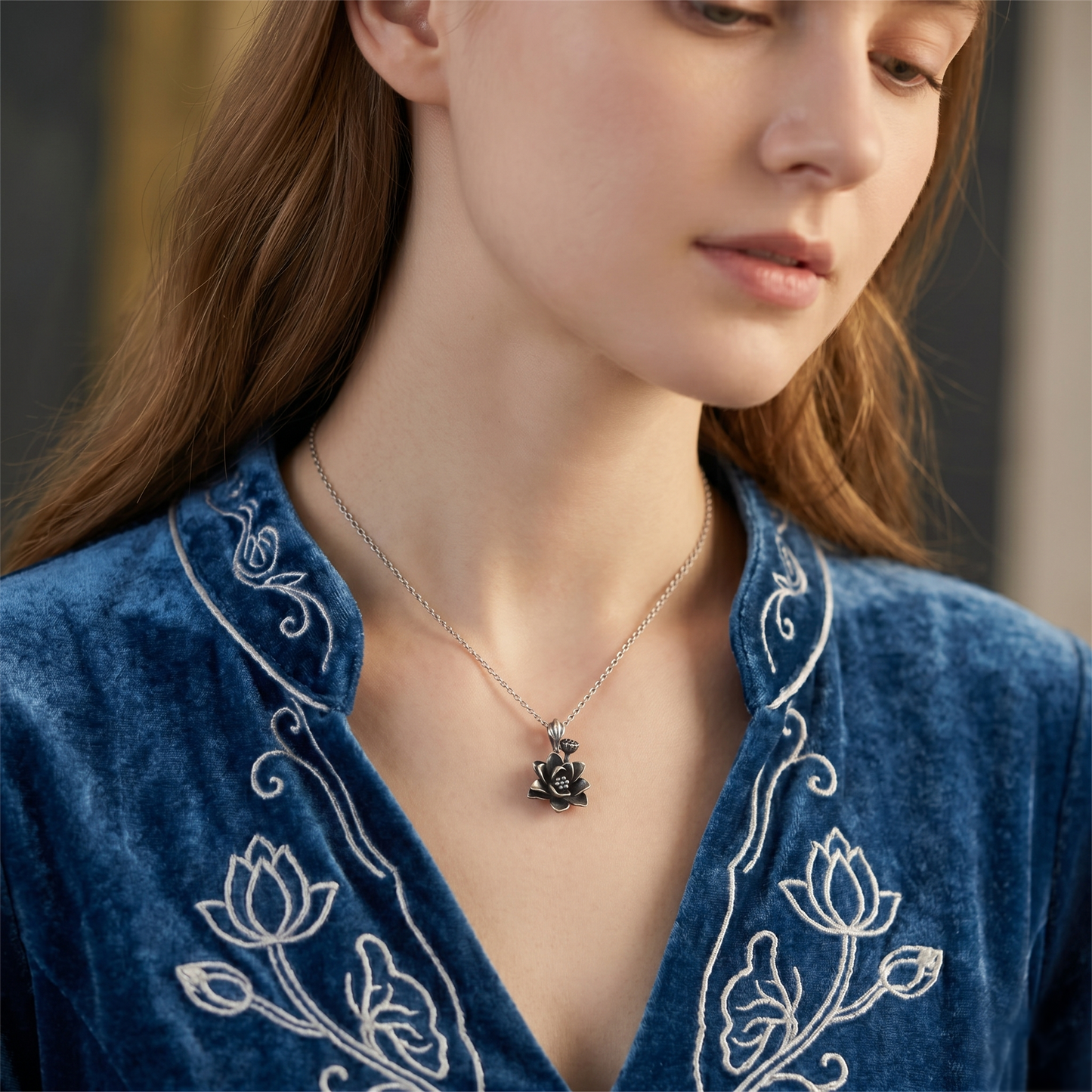 Lotus pendant necklace on a model, oxidized flower with dotted center and bail