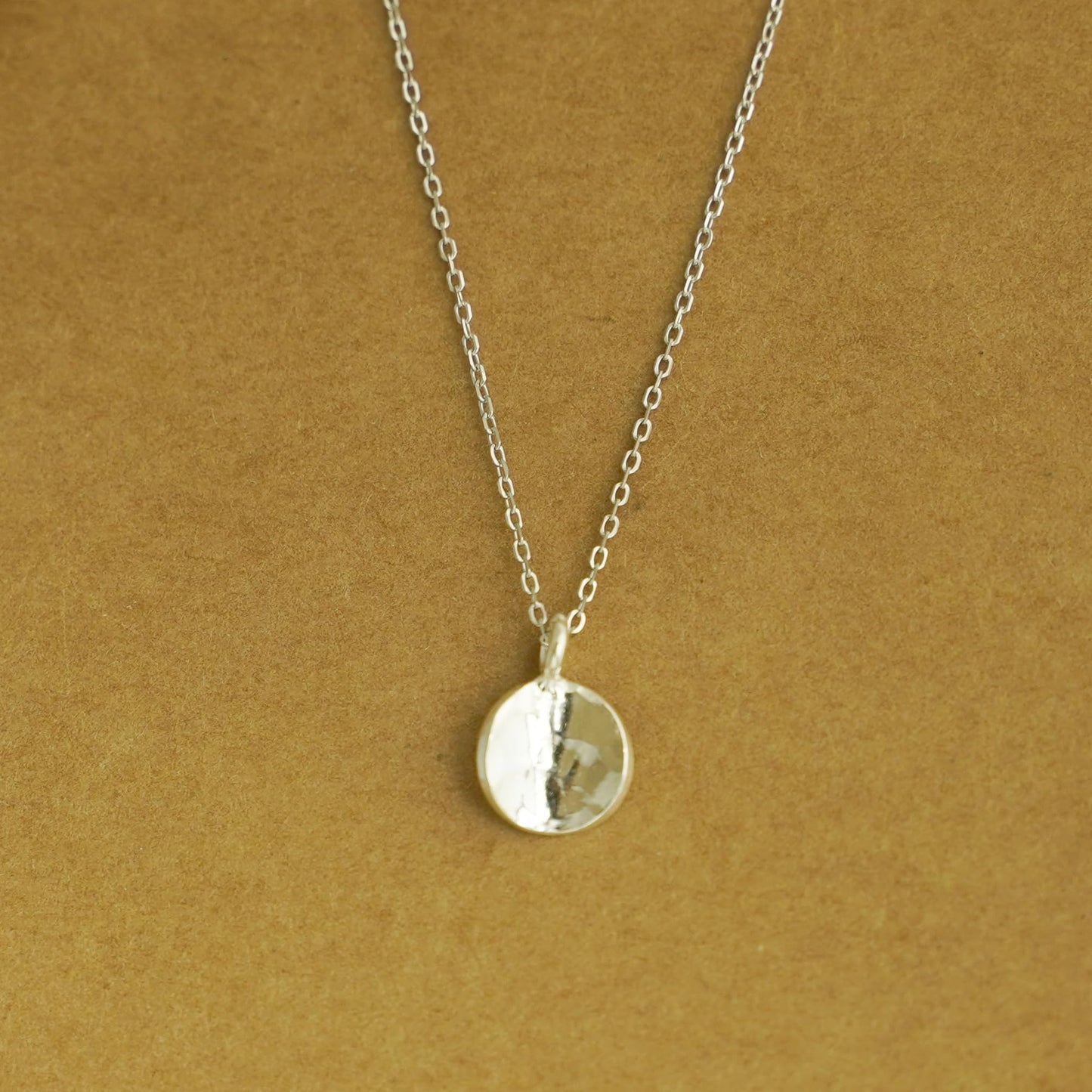Rhodium curb belcher chain necklace with round pendant, silver tone.