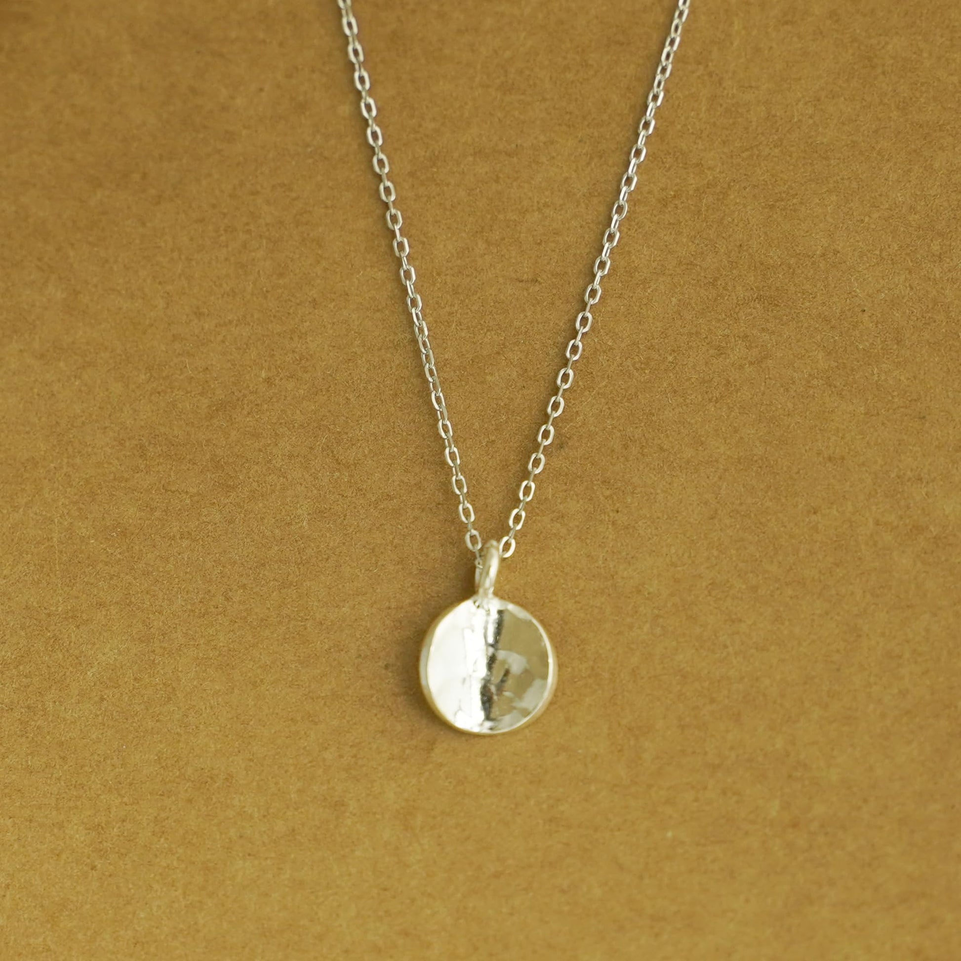 Rhodium curb belcher chain necklace with round pendant, silver tone.