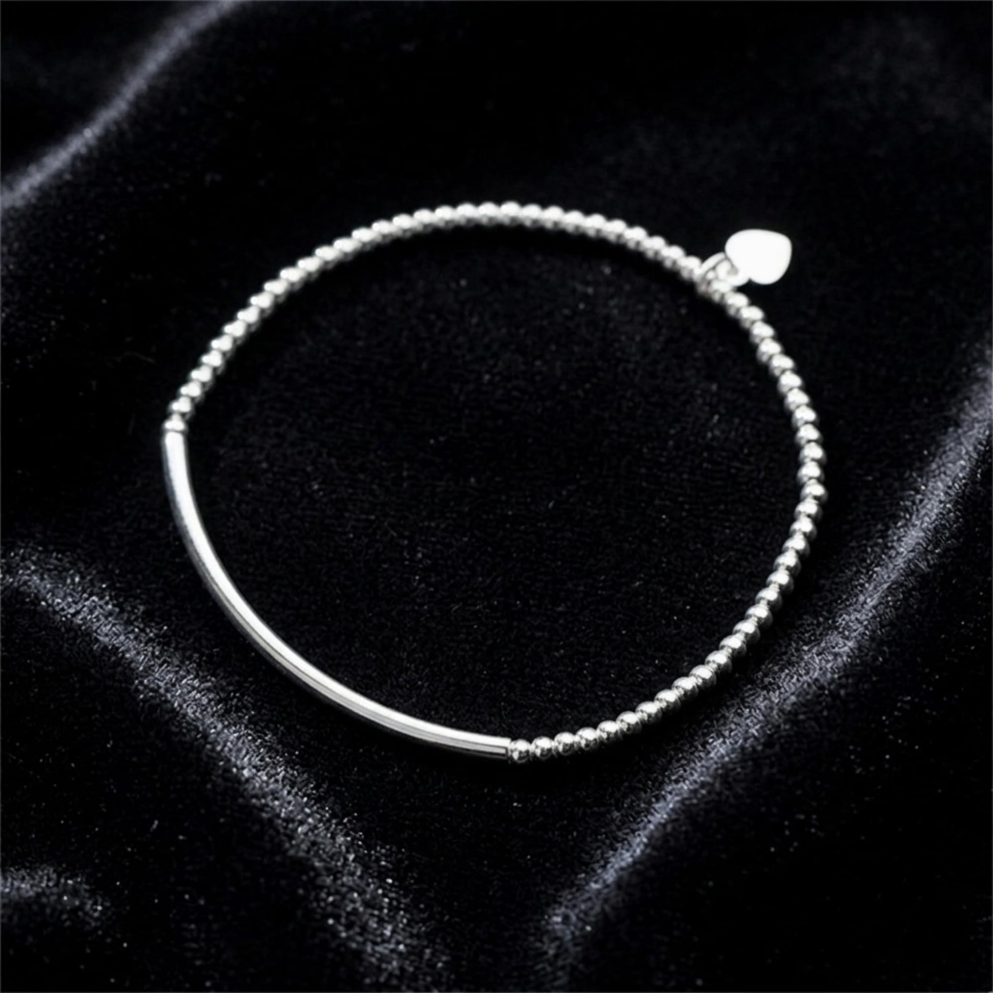 Silver beaded stretch bracelet with heart charm and smooth curved bar