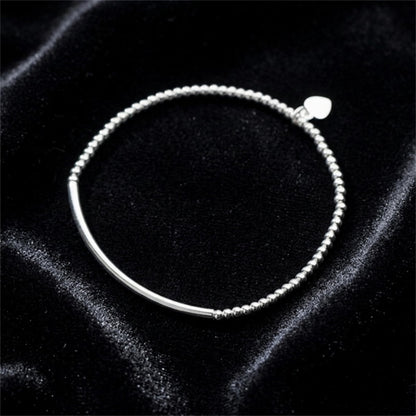 Silver beaded stretch bracelet with heart charm and smooth curved bar