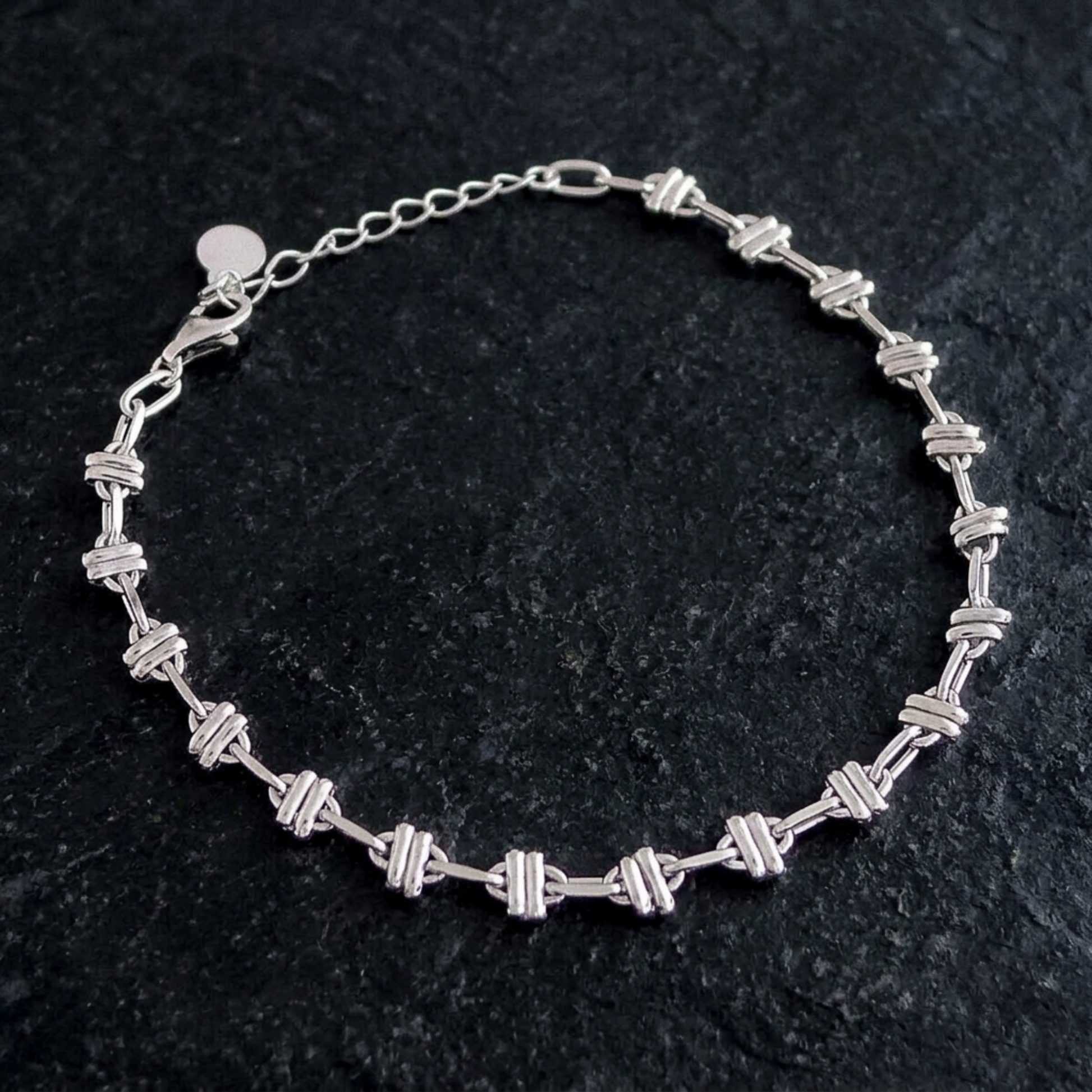 Silver-tone rope curb bracelet with oval links and round clasp at one end