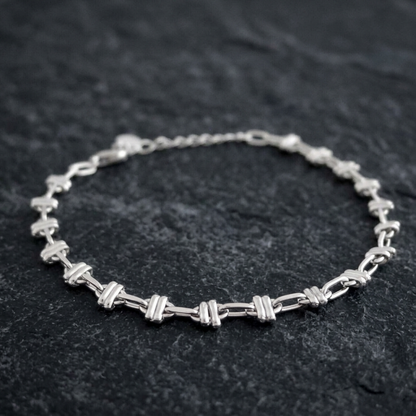 Silver-tone oval curb bracelet with alternating link segments and chain clasp