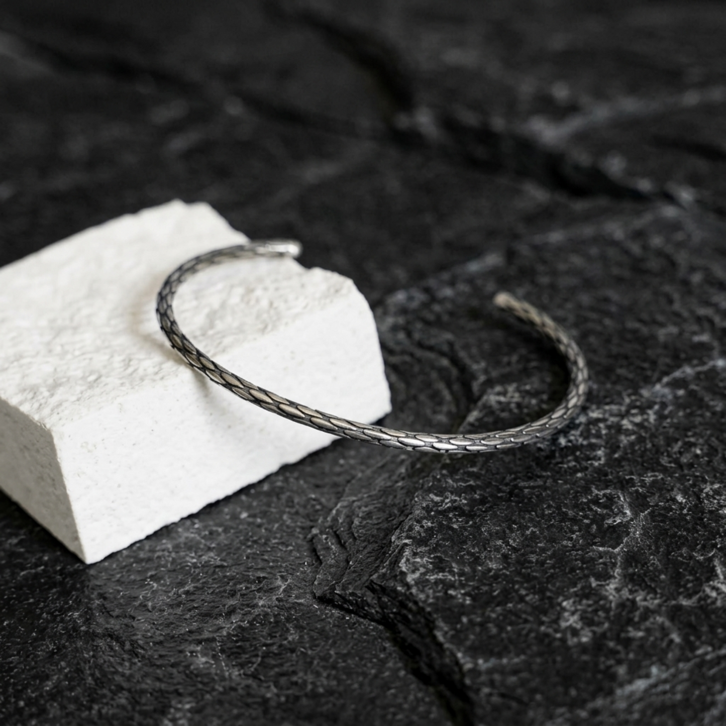 Snake-knot cuff bangle, silver-toned braided wire loop with textured pattern