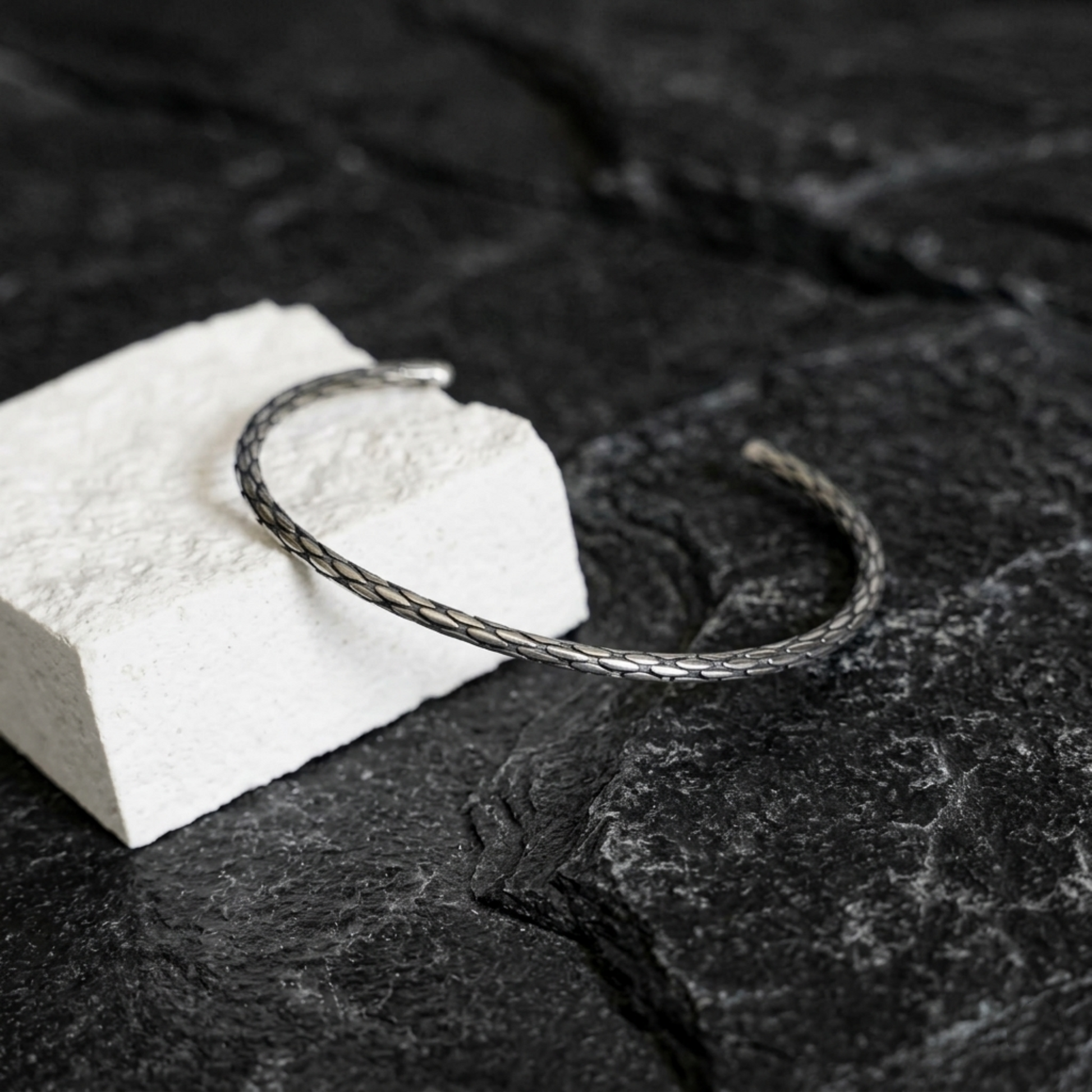 Snake-knot cuff bangle, silver-toned braided wire loop with textured pattern